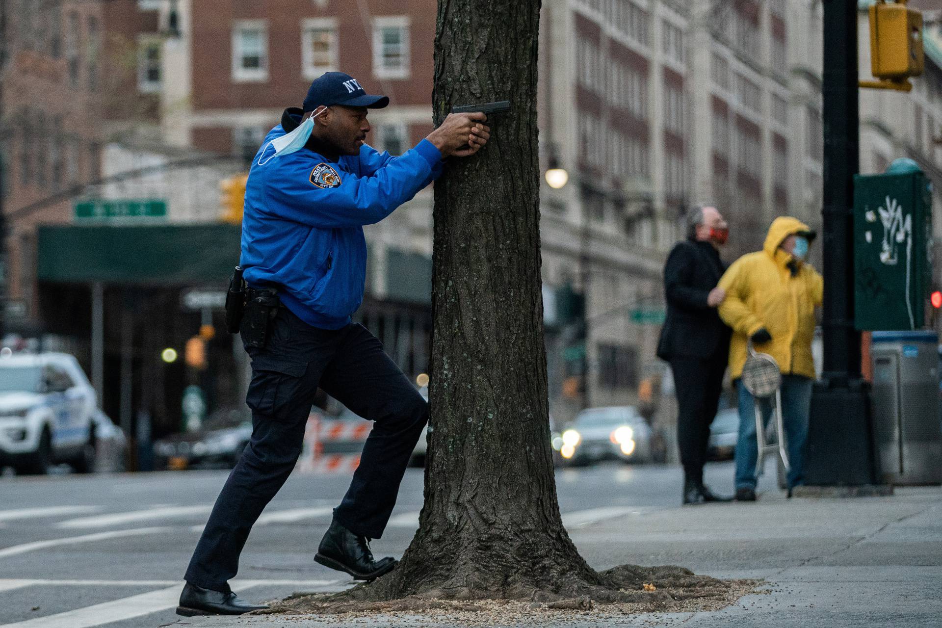 A police officer stands guard while a man is  shooting outside the Cathedral Church of St. John the Divine in the Manhattan borough of New York City