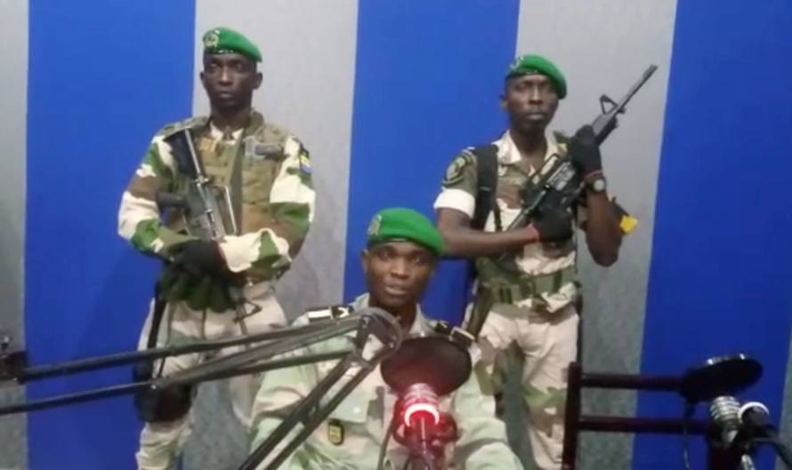 A still image taken from a video shows military officers giving a statement from a radio station in Libreville