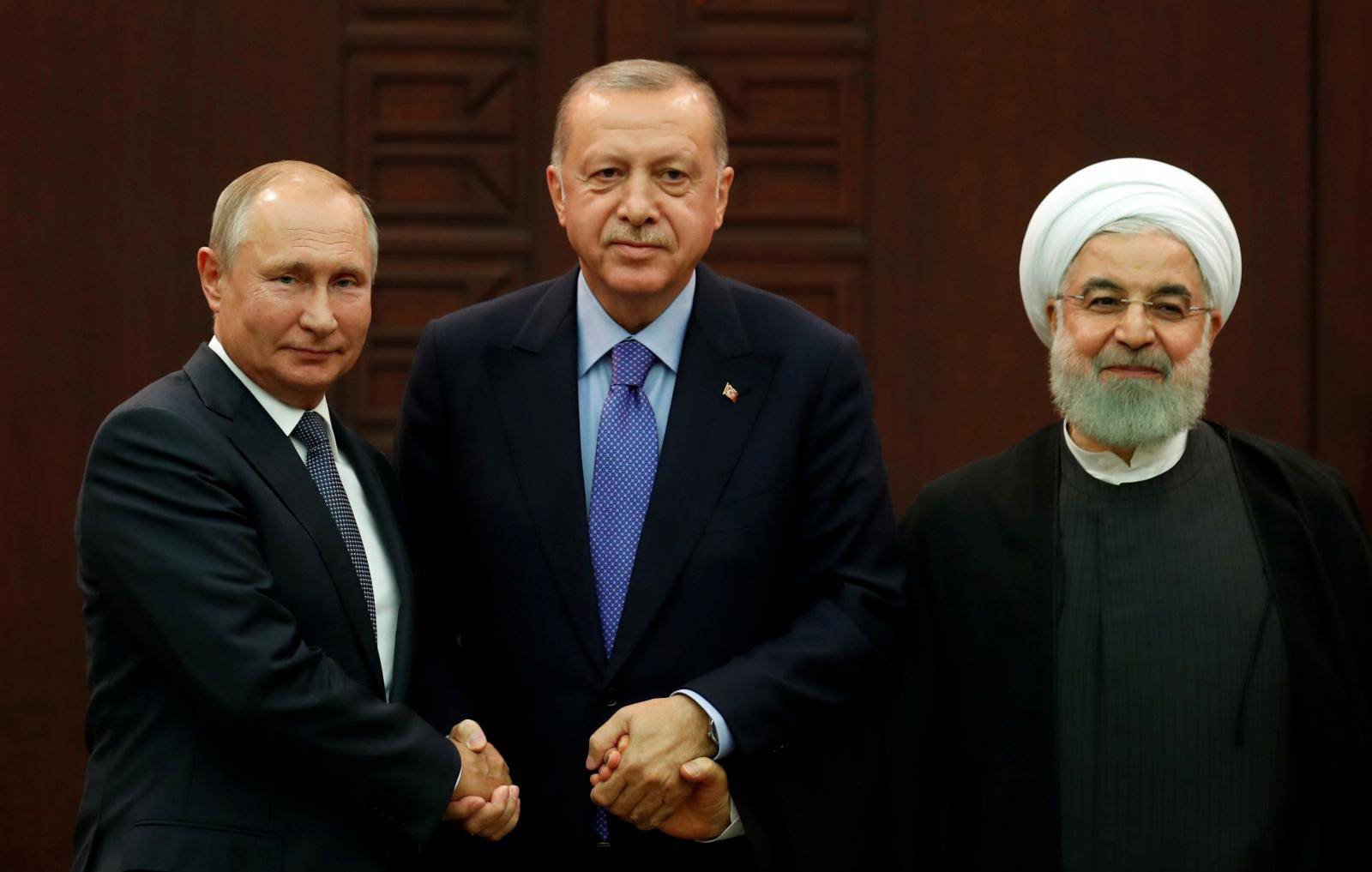 Presidents Putin of Russia, Erdogan of Turkey and Rouhani of Iran pose following a joint news conference in Ankara
