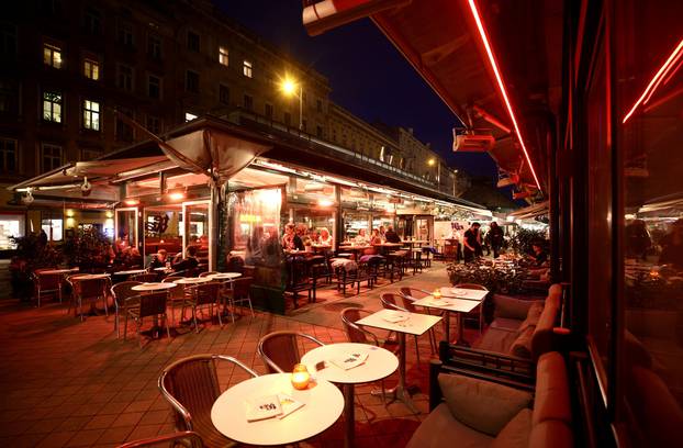 People share time at a cafe bar at Naschmarkt market the evening before the start of the second lockdown amid the coronavirus disease (COVID-19) outbreak in Vienna