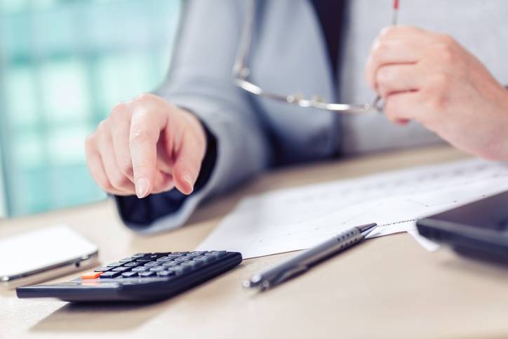 Accountant doing calculations on his calculator