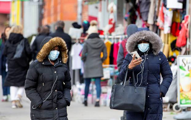 Pedestrians walk in the Chinatown district of downtown Toronto