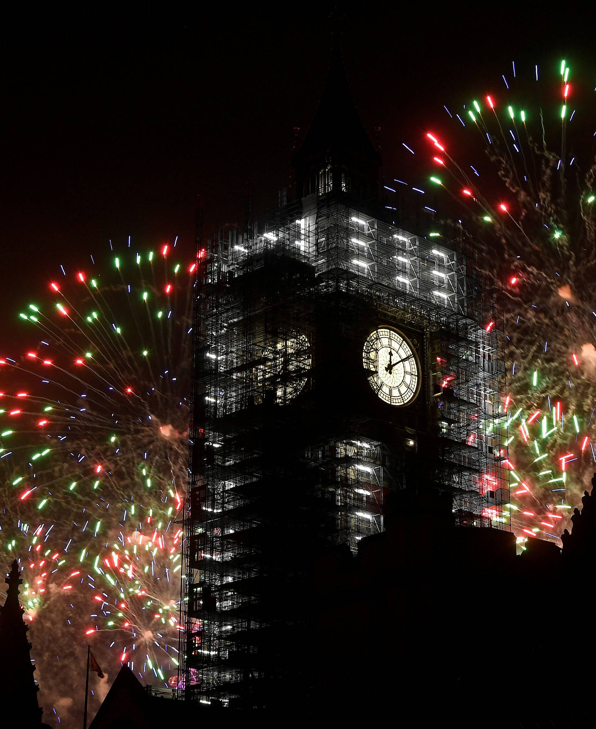 Fireworks explode behind the Elizabeth Tower, commonly known as Big Ben, during New Year's Eve celebrations in London, Britain