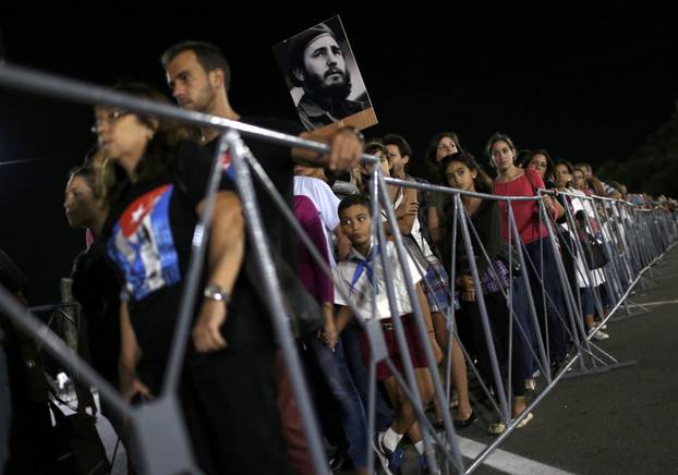 People wait in line to pay tribute to Cuba