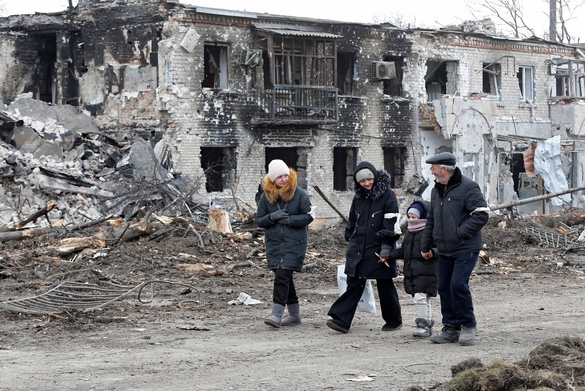 Local residents walk along a street in Volnovakha
