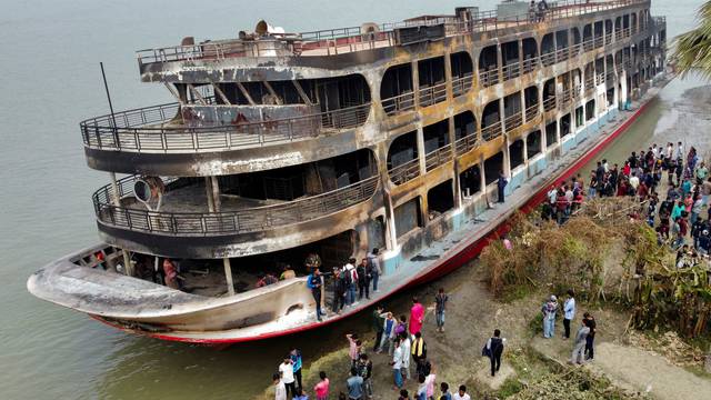 Burnt passenger ferry is seen anchored on the bank of Sugandha River which caught on a fire that killed several dozens in Jhalalathi