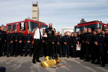 Tyson Fury presents tickets to LA firefighters ahead of his WBC heavyweight title fight with Deontay Wilder