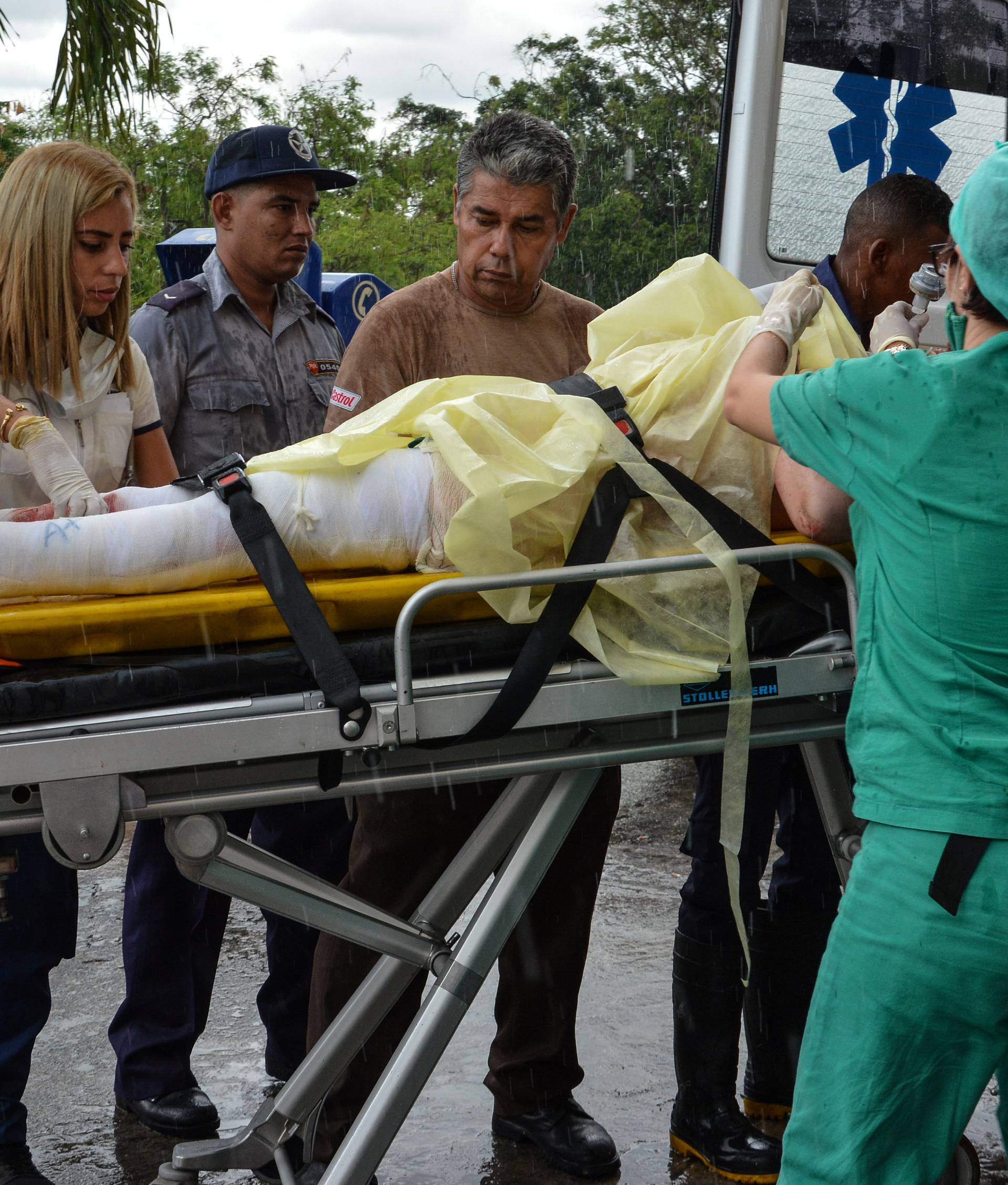A survivor of a Boeing 737 plane that crashed in the agricultural area of Boyeros shortly after taking off from Havana's main airport receives medical care