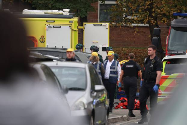 Police officers work at the scene following an incident outside a synagogue, in Manchester