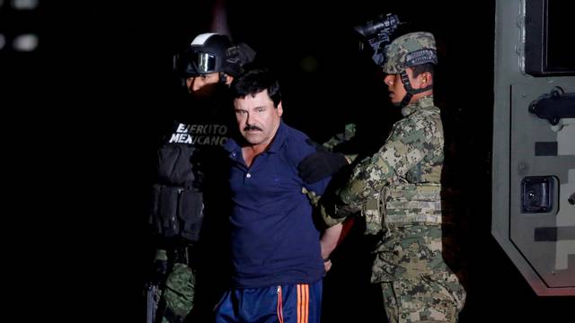 FILE PHOTO: Joaquin "El Chapo" Guzman is escorted by soldiers during a presentation in Mexico City