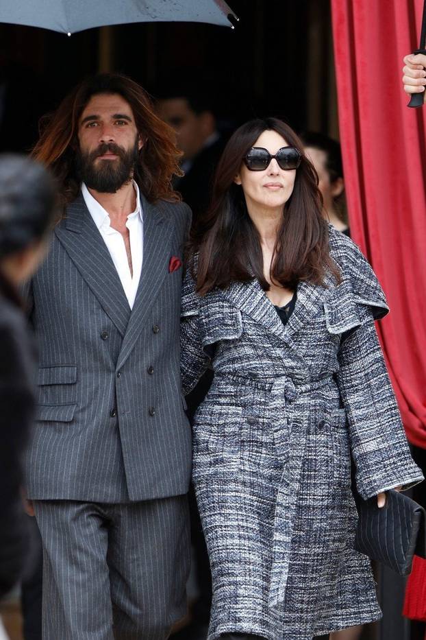 Sexy Italian actress Monica Bellucci and new boyfriend Nicolas Lefevre make their way to their car after a day of attending events during Paris Fashion Week.