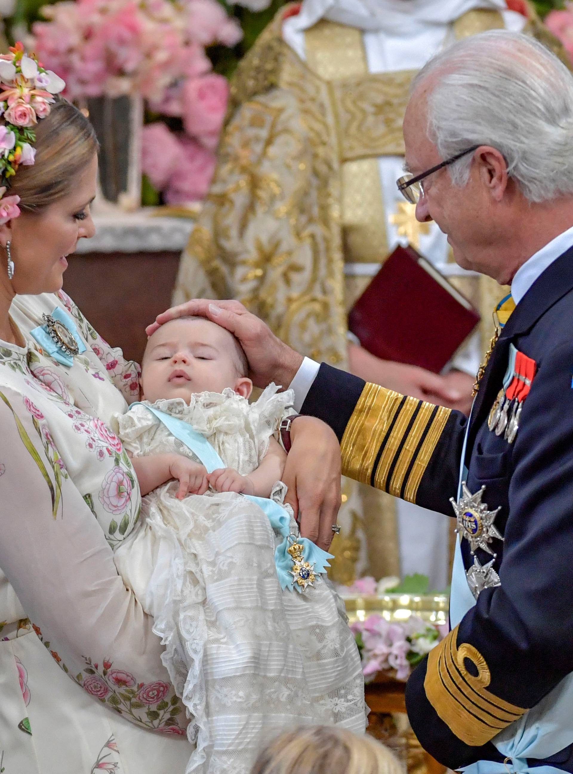 Princess Madeleine and king Carl Gustaf are seen during princess Adrienne's christening ceremony  in Drottningholm Palace Chapel outside Stockholm