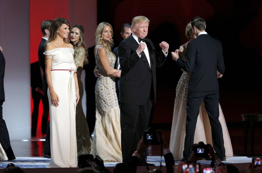 U.S. President Trump pumps his fists with wife Melania and members of their family after dancing their first dance to Frank Sinatra's song "My Way" at his "Liberty" Inaugural Ball in Washington