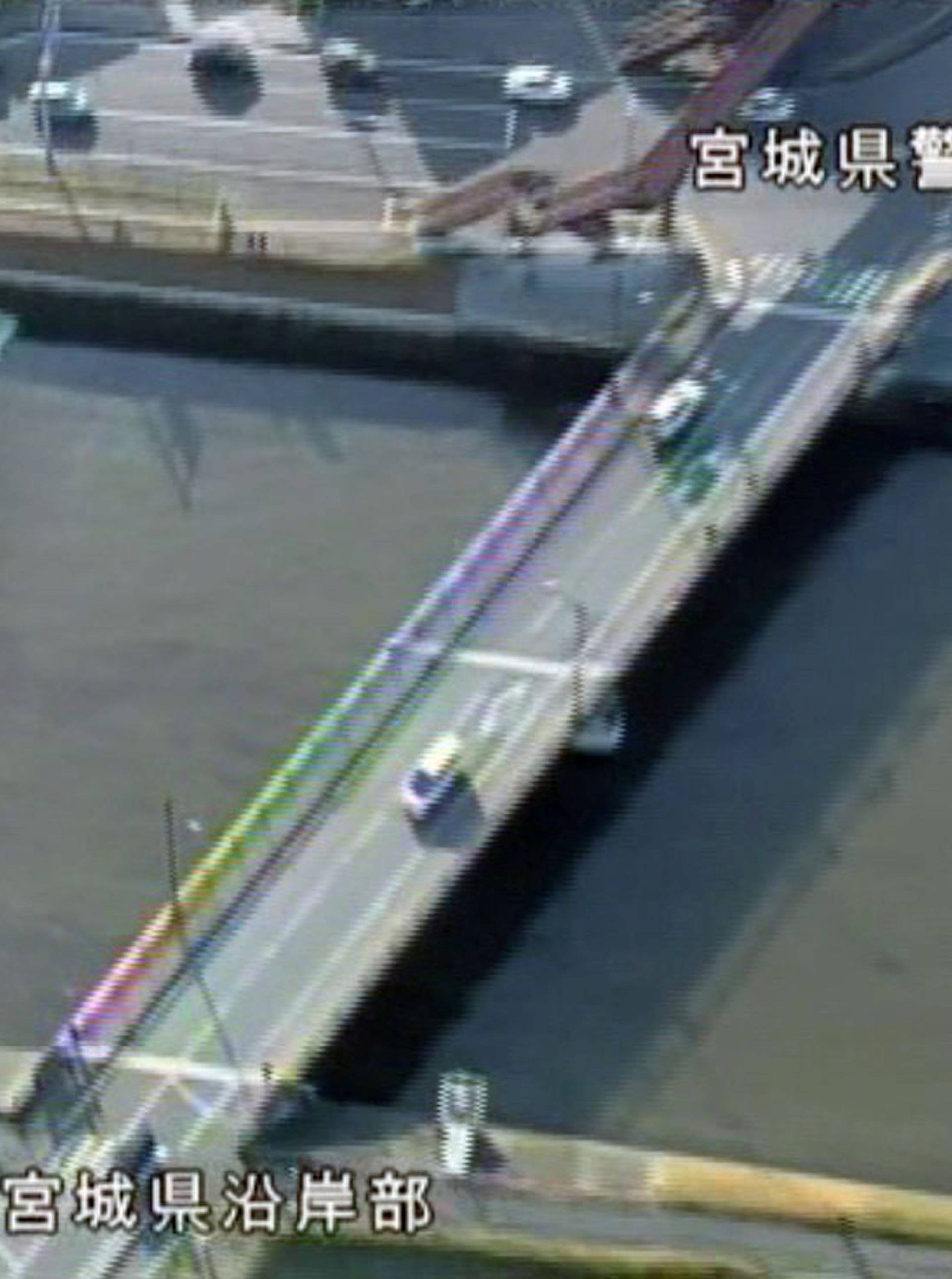 A tidal surge is seen in Sunaoshi River after tsunami advisories were issued following an earthquake in Tagajo, Miyagi prefecture