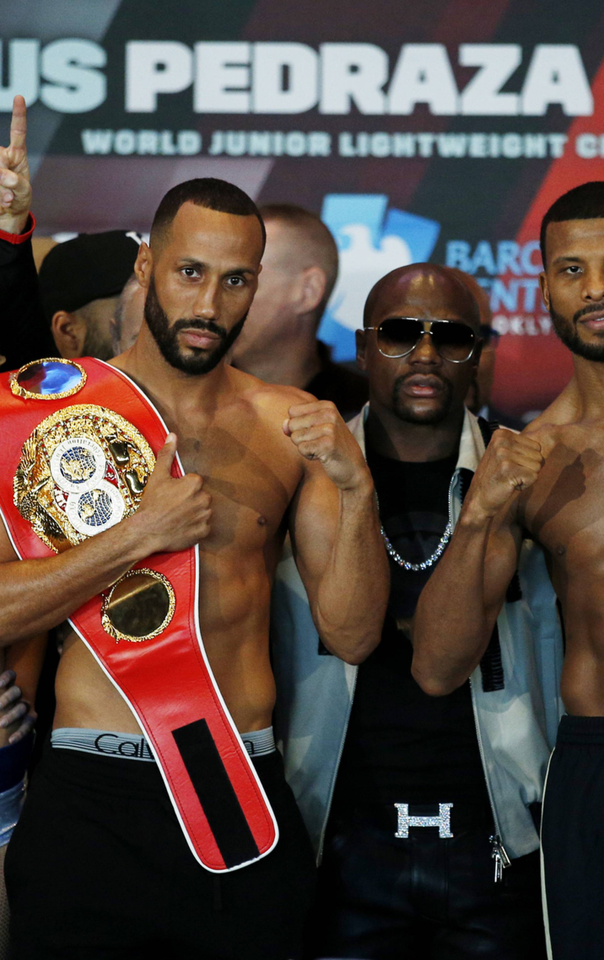 James DeGale and Badou Jack pose during the weigh in with Floyd Mayweather