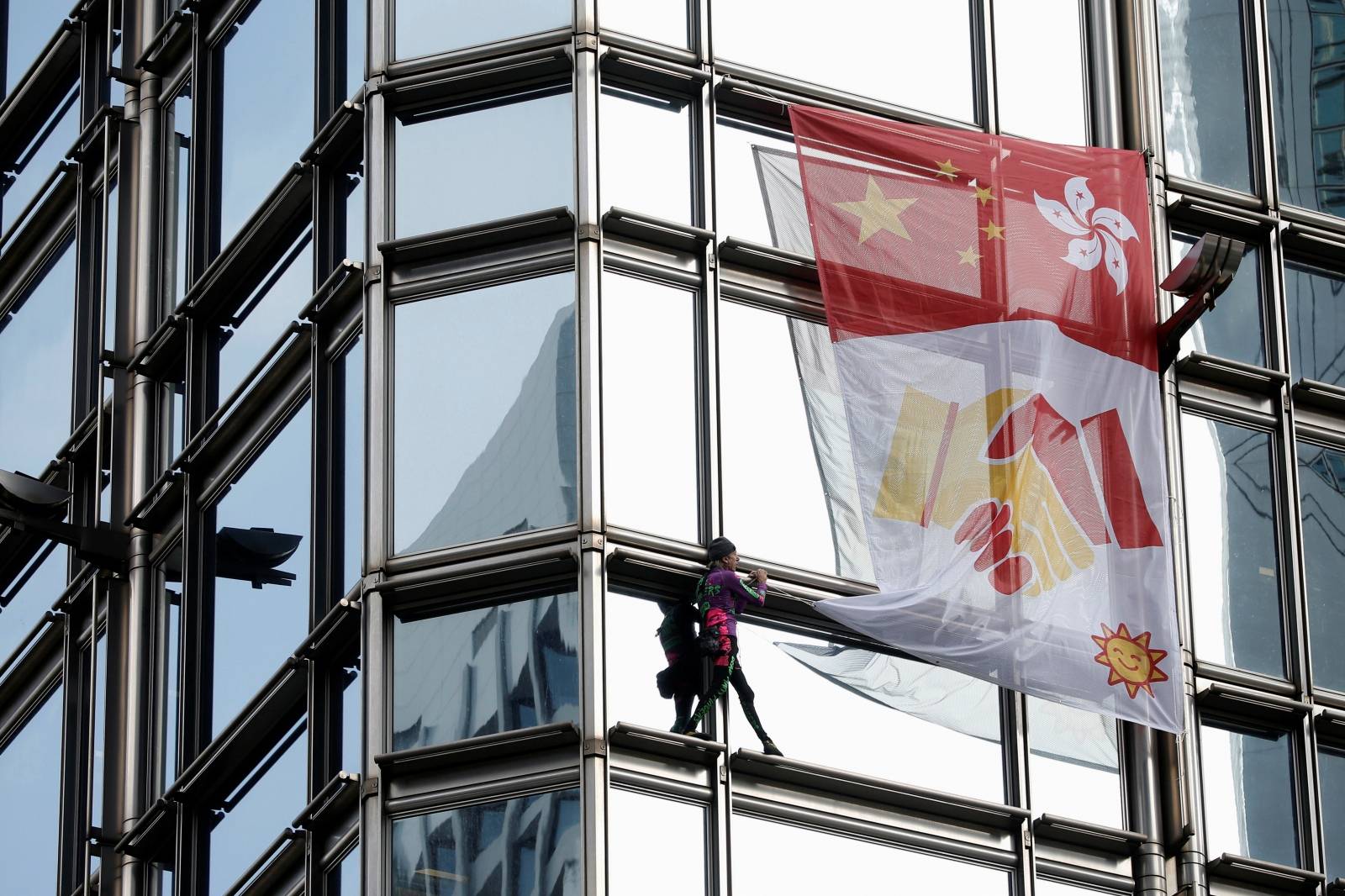 French urban climber Alain Robert climbs the Cheung Kong Center building in Hong Kong