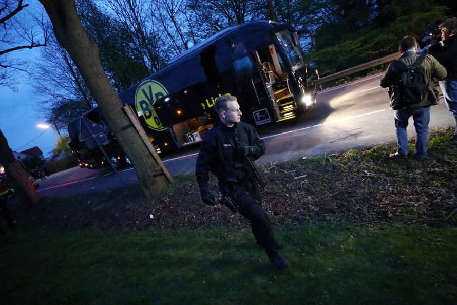 Police with the Borussia Dortmund team bus after an explosion near their hotel before the game
