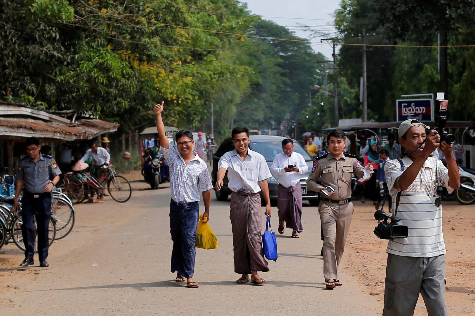 Reuters reporters Wa Lone and Kyaw Soe Oo gesture as they walk free outside Insein prison after receiving a presidential pardon in Yangon