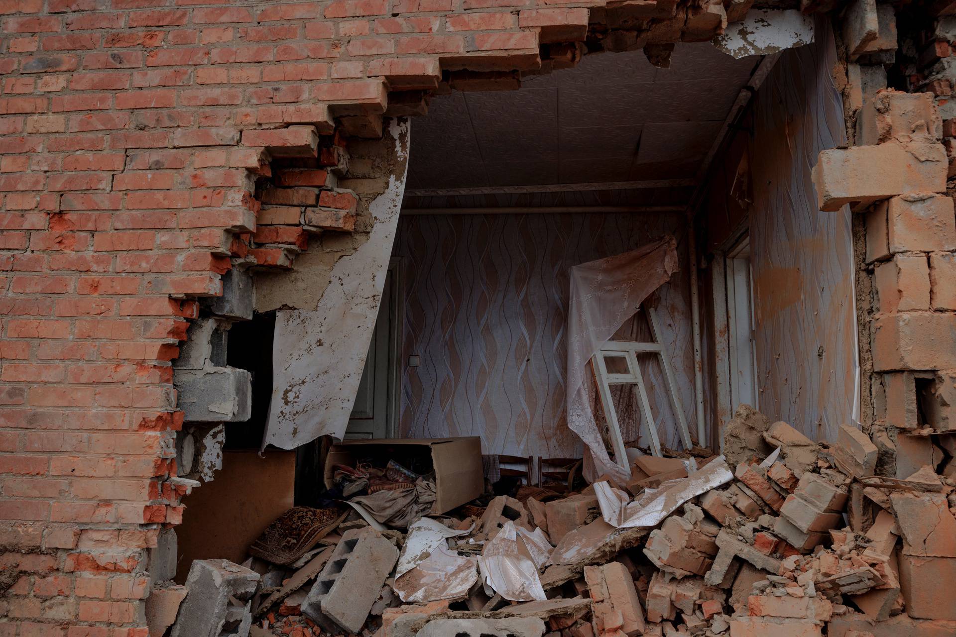 Debris covers the floor in a house that was directly hit by a projectile during heavy shelling in the town of Derhachi outside Kharkiv