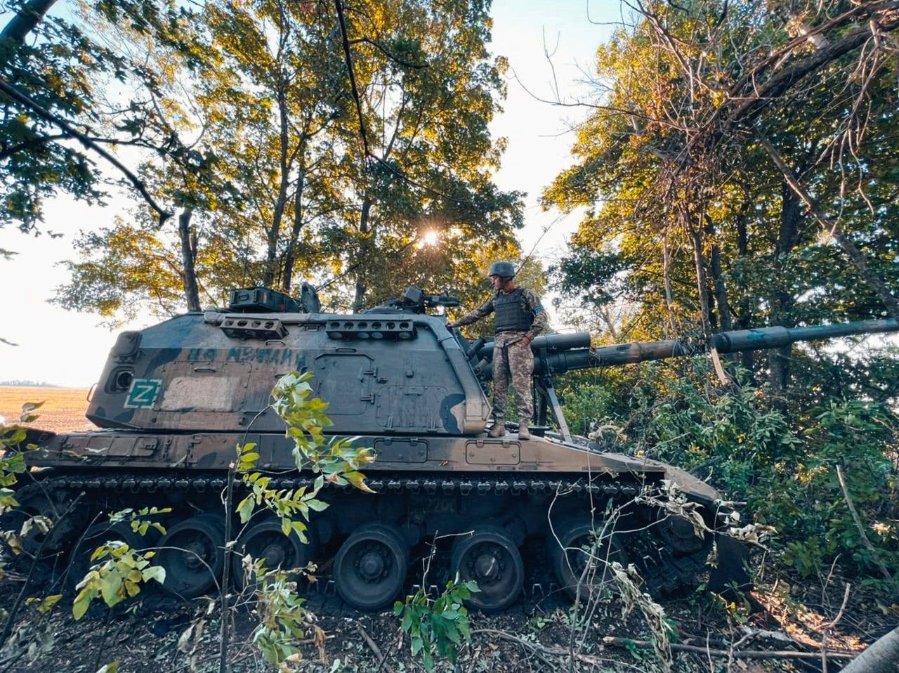 FILE PHOTO: Ukrainian service member stands on a Russian 2S19 Msta-S self-propelled howitzer captured during a counteroffensive operation in Kharkiv region