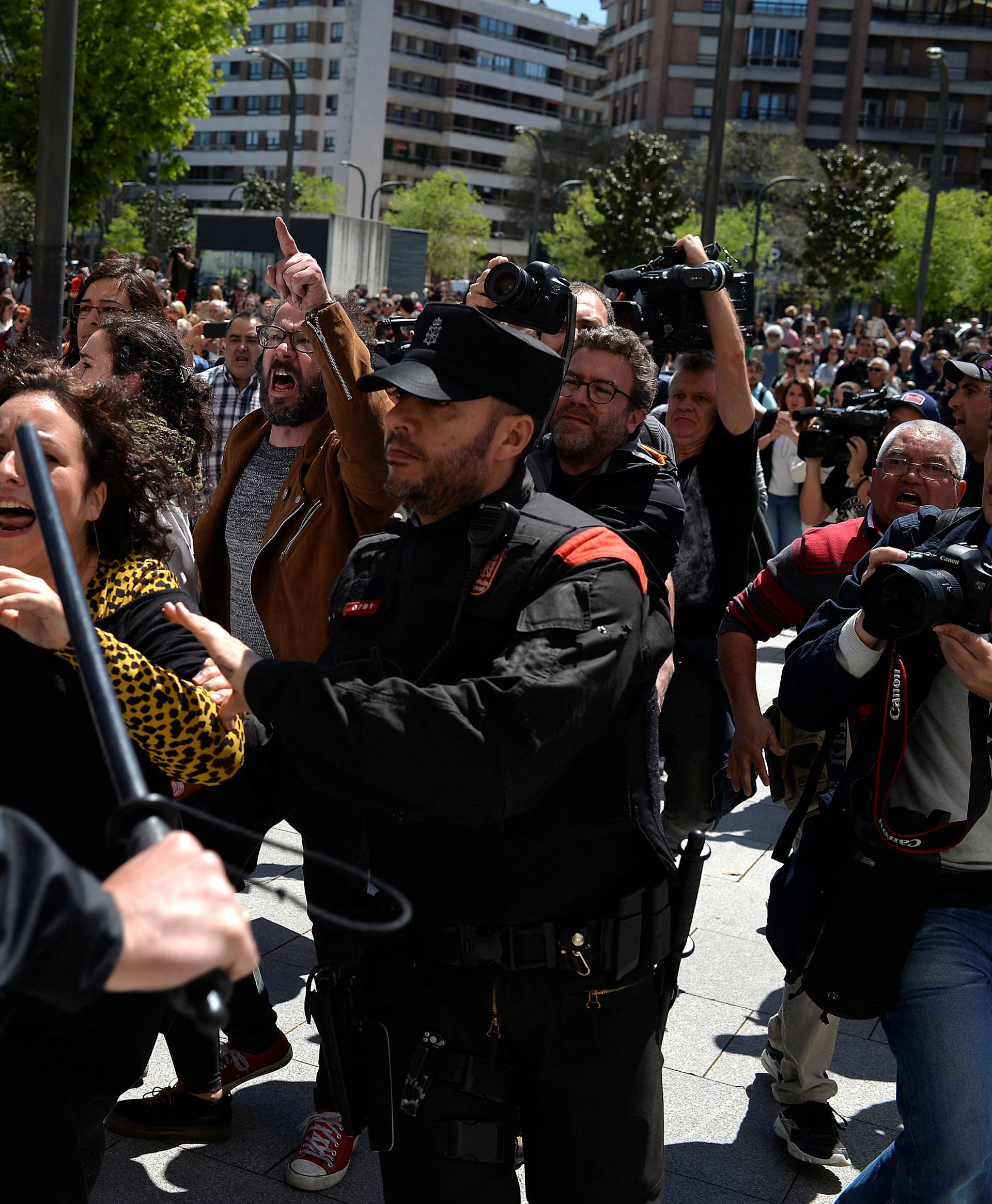 A protester breaks through a police line after a nine-year sentence was given to five men accused of the multiple rape of a woman during Pamplona's San Fermin festival in 2016