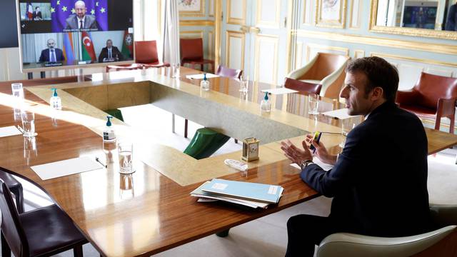 French President Emmanuel Macron holds a video conference at the Elysee Palace in Paris