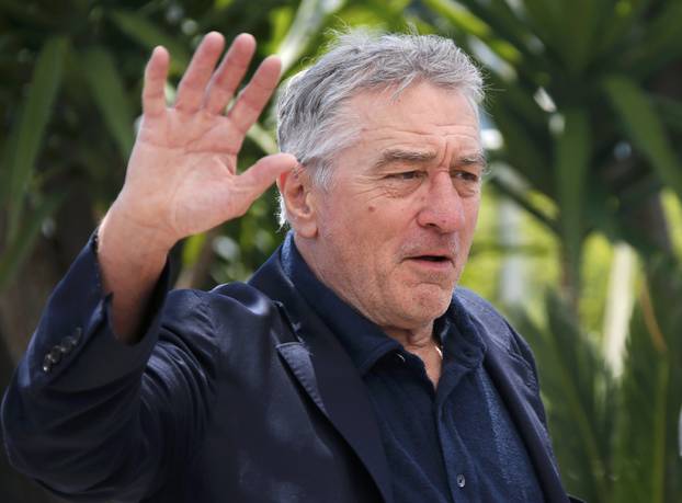 Cast member Robert De Niro waves as he arrives at a photocall for the film "Hands of stone" out of competition at the 69th Cannes Film Festival in Cannes