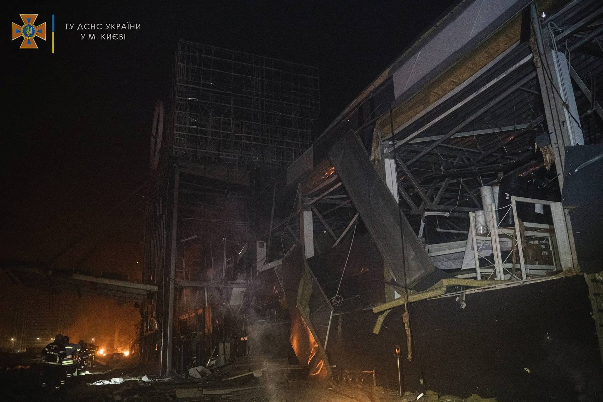 Rescuers work at the site of a shopping mall damaged by an airstrike in Kyiv