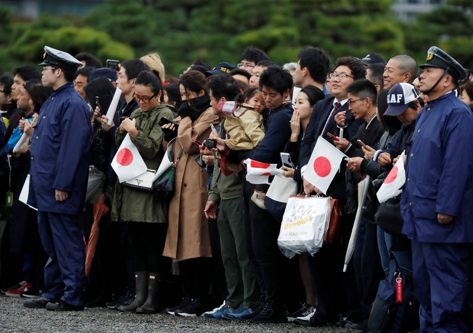 People wait outside the Imperial Palace after the enthronement ceremony of Japan's Emperor Naruhito in Tokyo