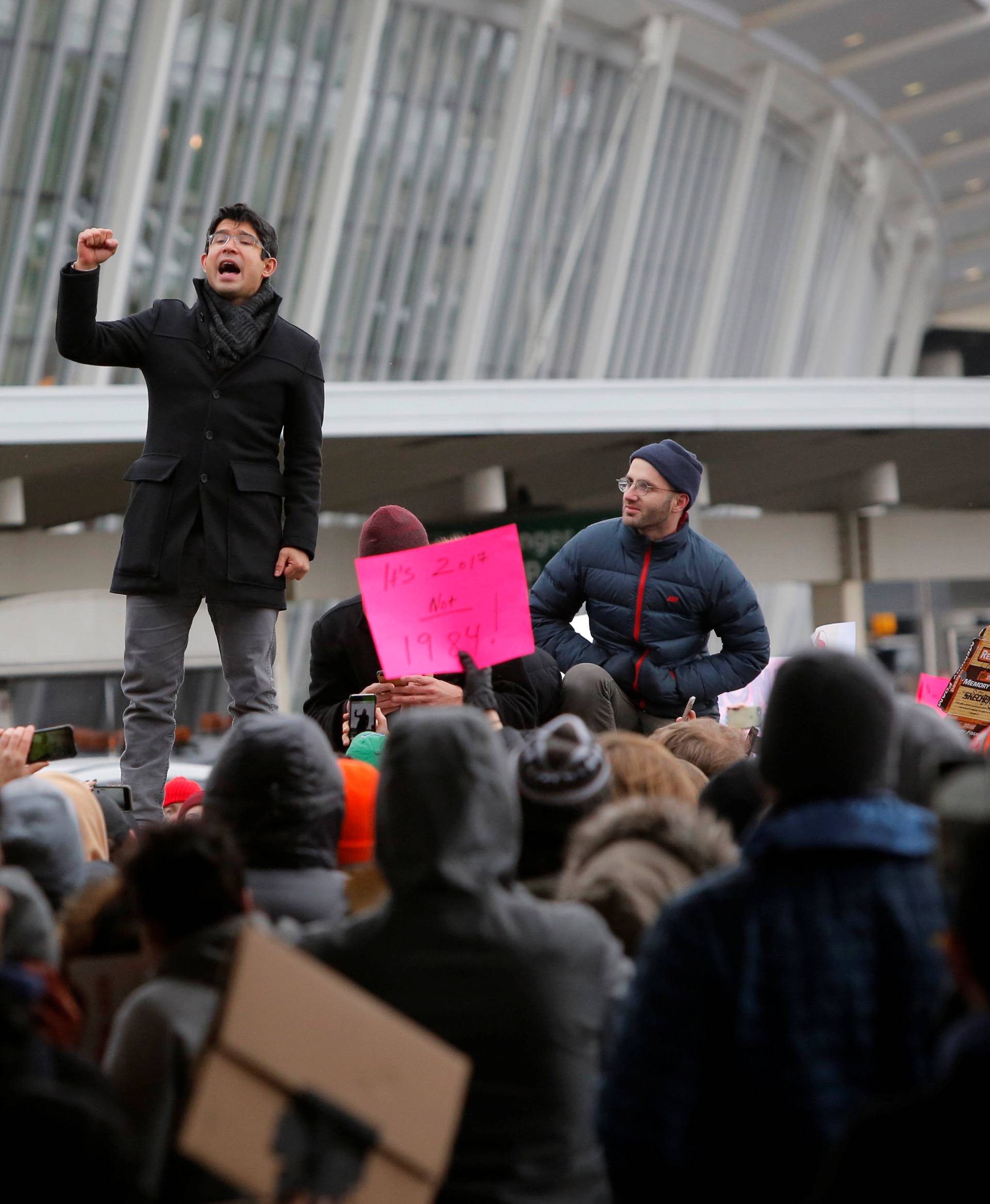 New York City Council Member Carlos Menchaca addresses a crowd during an anti-Donald Trump immigration ban protest outside Terminal 4 at John F. Kennedy International Airport in Queens