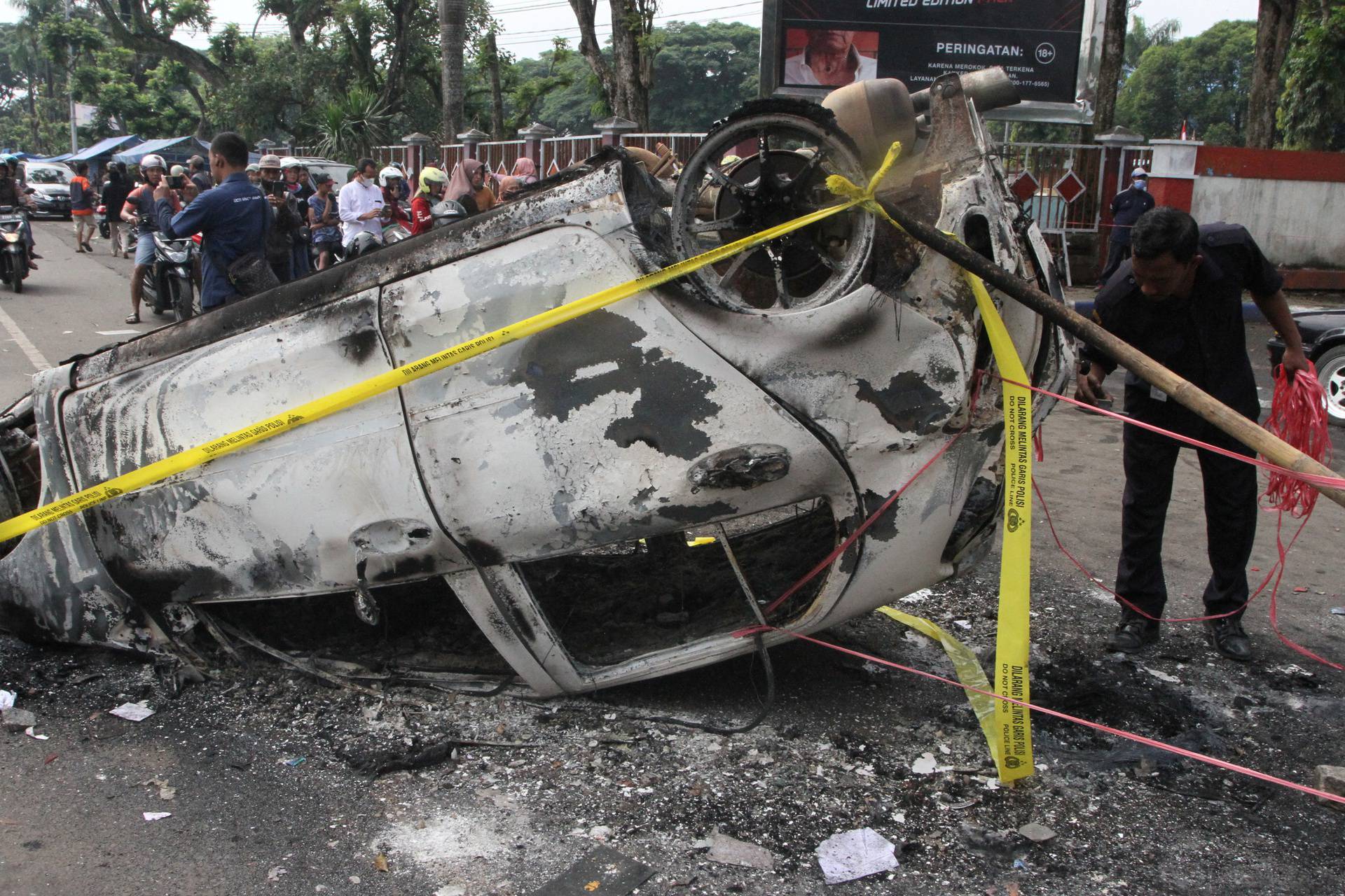 A damaged car is pictured following a riot after the league BRI Liga 1 football match between Arema vs Persebaya at Kanjuruhan Stadium