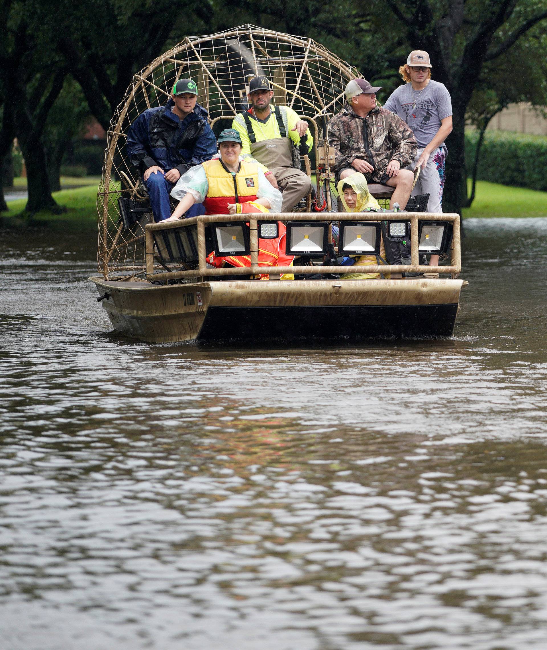 A woman is evacuated by airboat from the Hurricane Harvey floodwaters in Houston