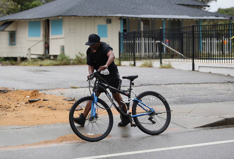 A man navigates through a gust of wind during Hurricane Florence in Myrtle Beach