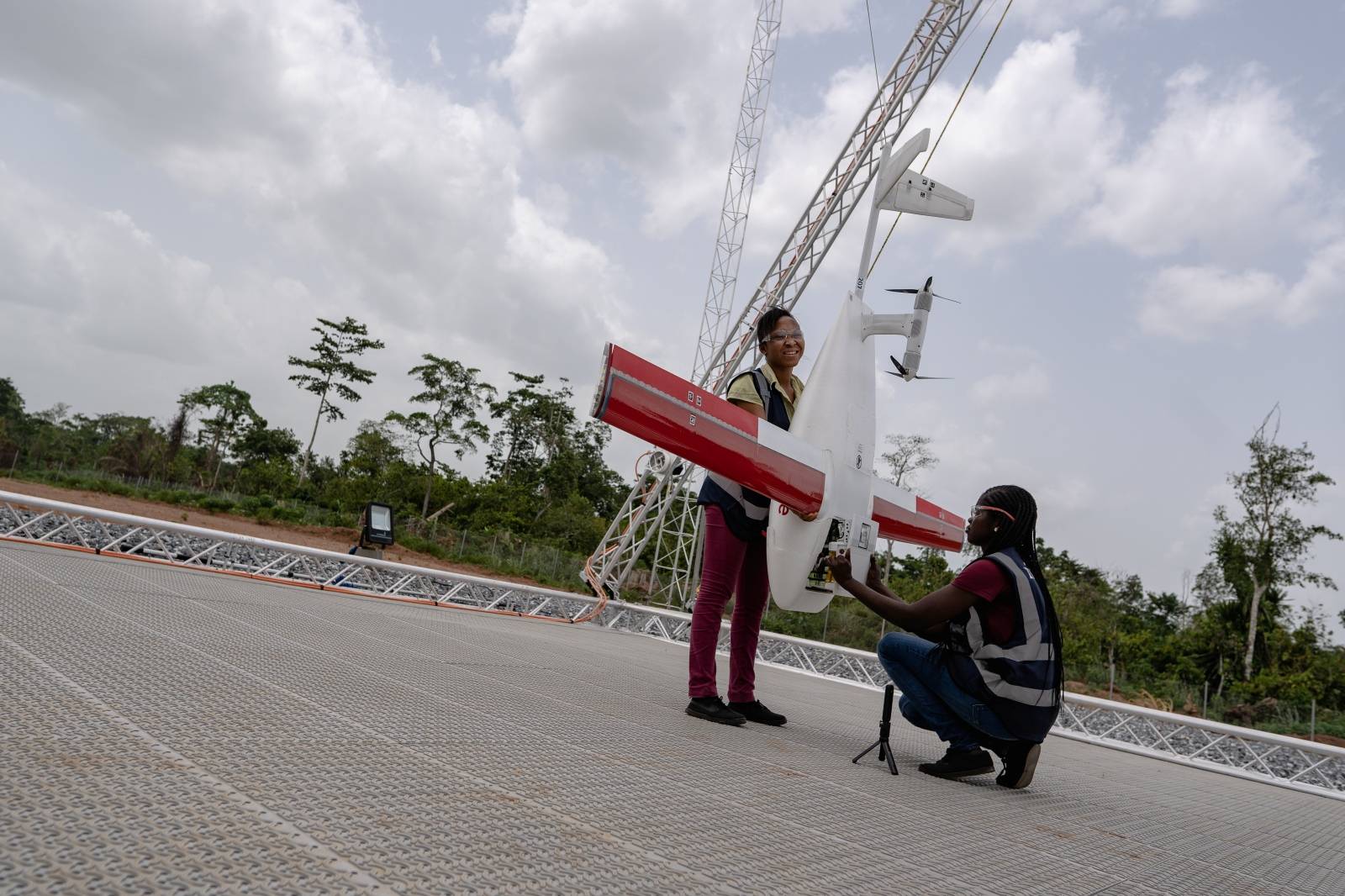 Workers pack a box of vaccines to be delivered by a Zipline drone, in Ghana