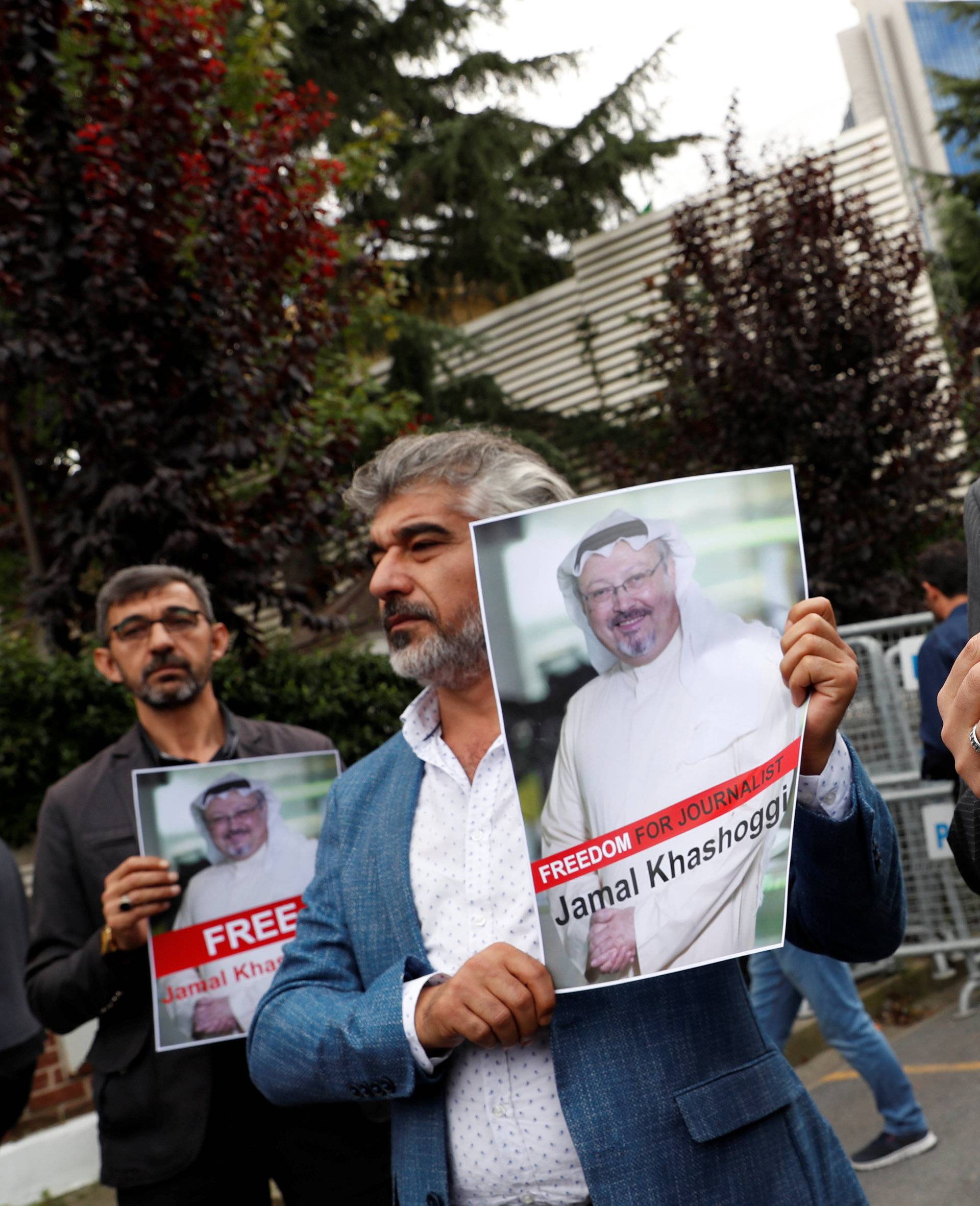 Human rights activists and friends of Saudi journalist Khashoggi hold his pictures during a protest outside the Saudi Consulate in Istanbul