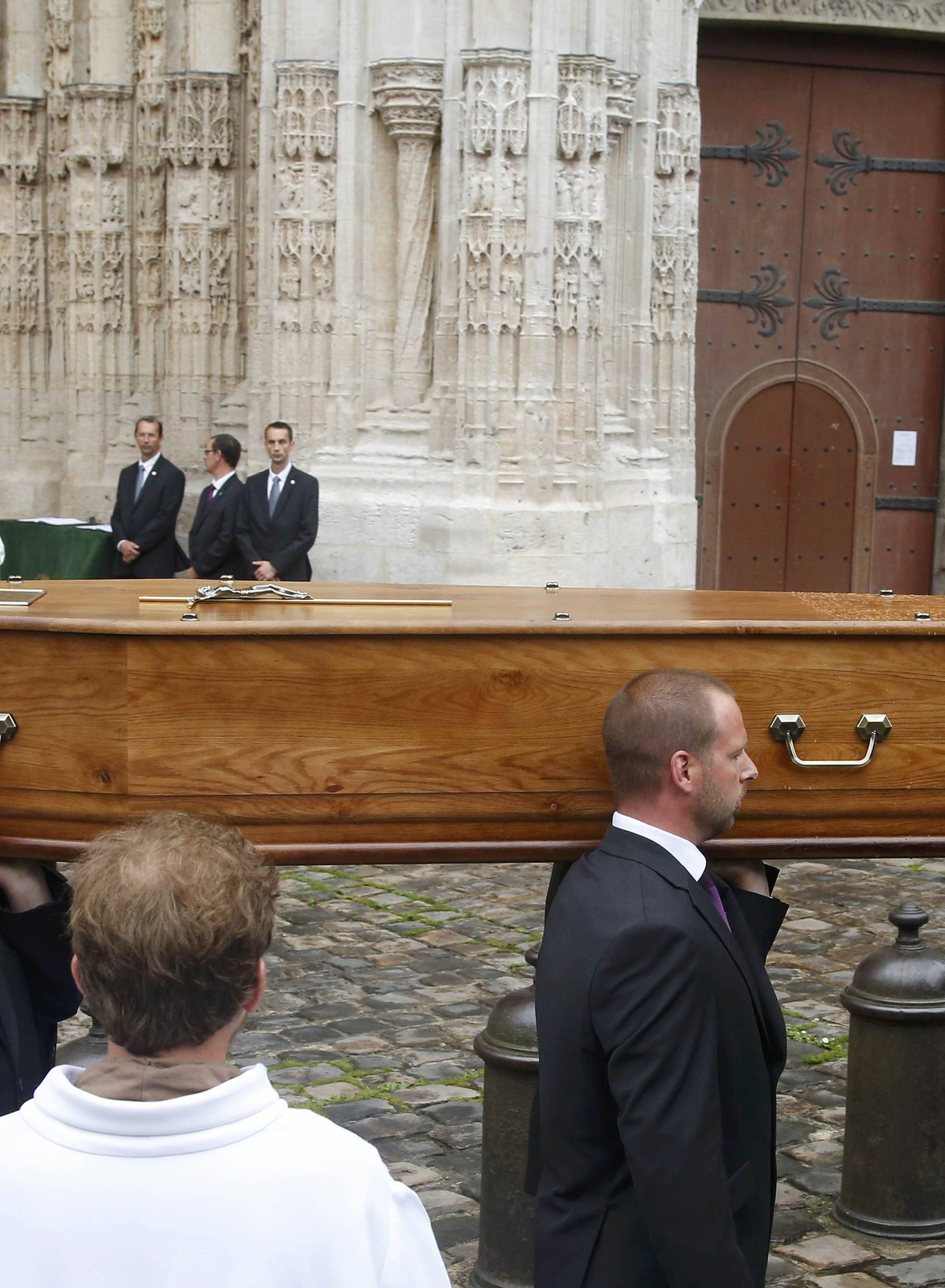 Pallbearers carry the coffin of slain French parish priest Father Jacques Hamel after a funeral ceremony at the Cathedral in Rouen