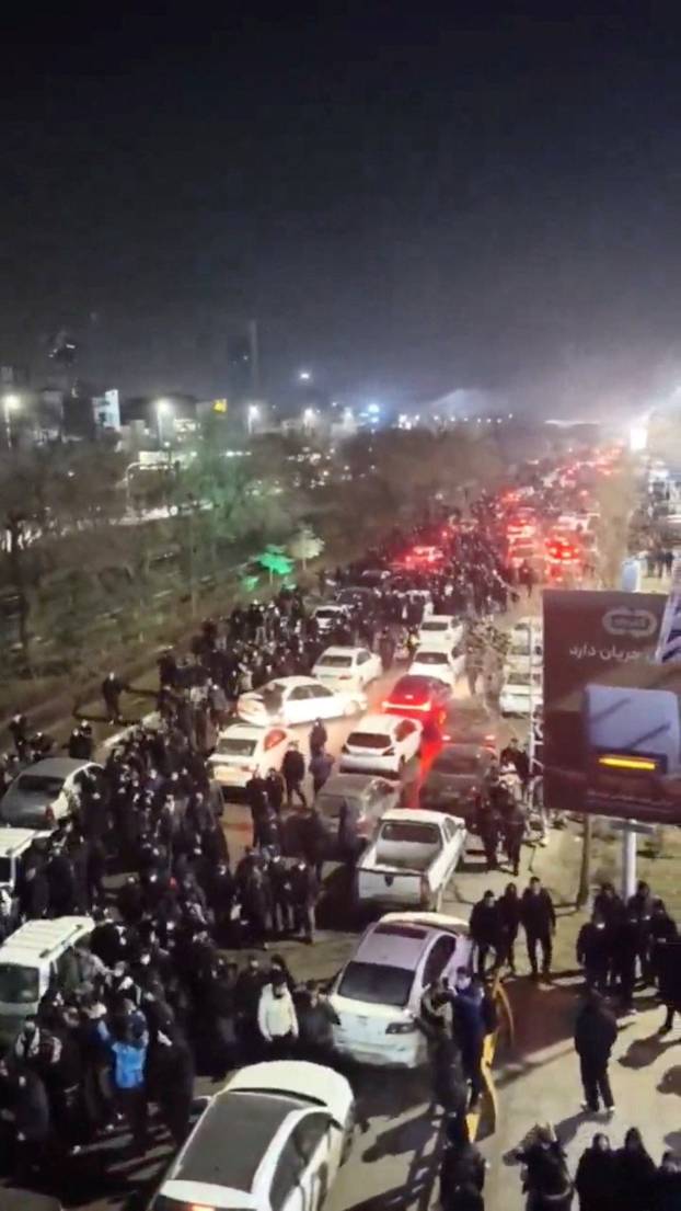 People gather on the streets during a protest in Mashhad