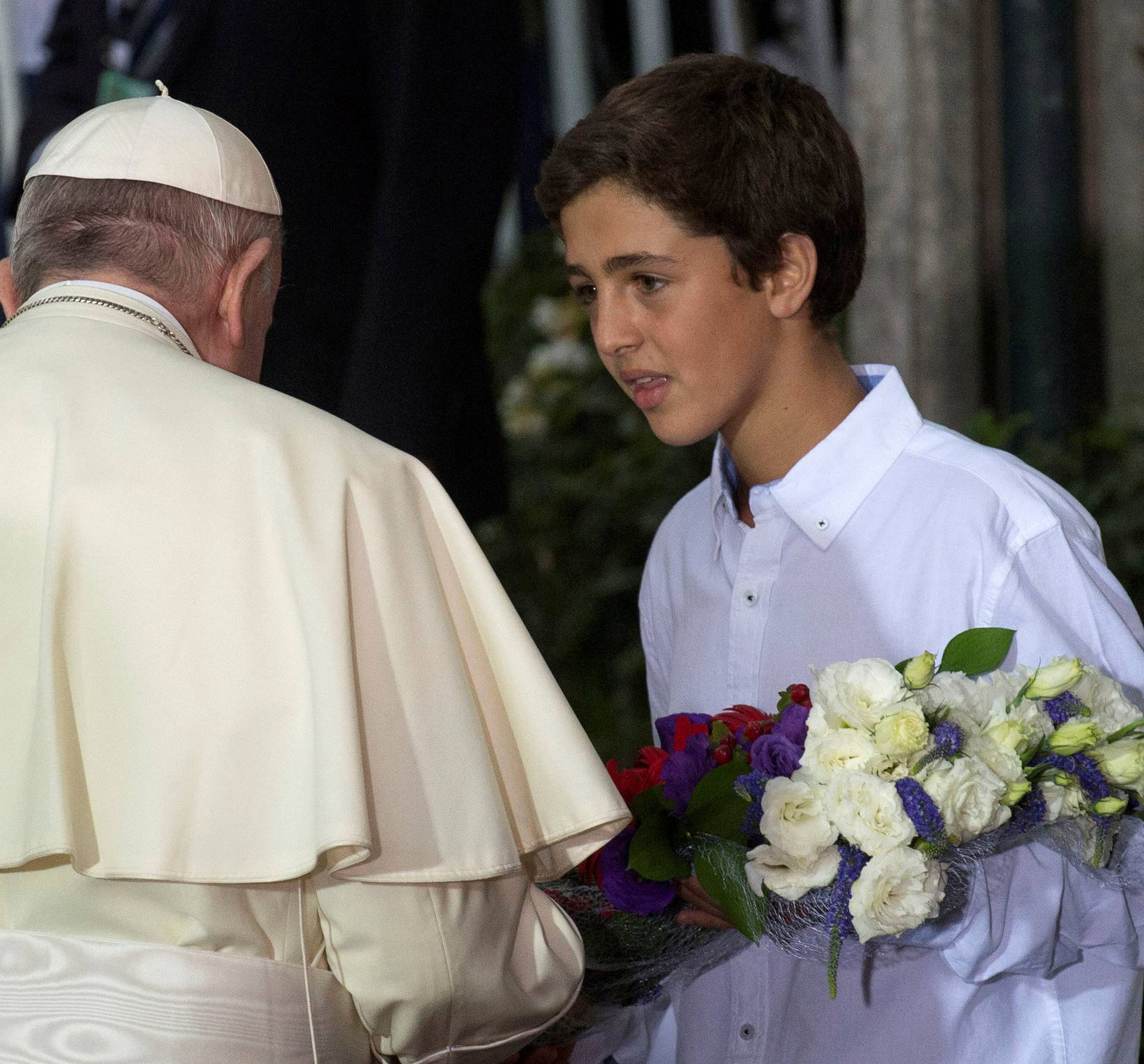 Pope Francis receives flowers outside the nunciature in Santiago