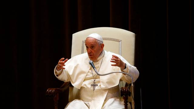 Pope Francis gestures during a meeting with children at the Vatican