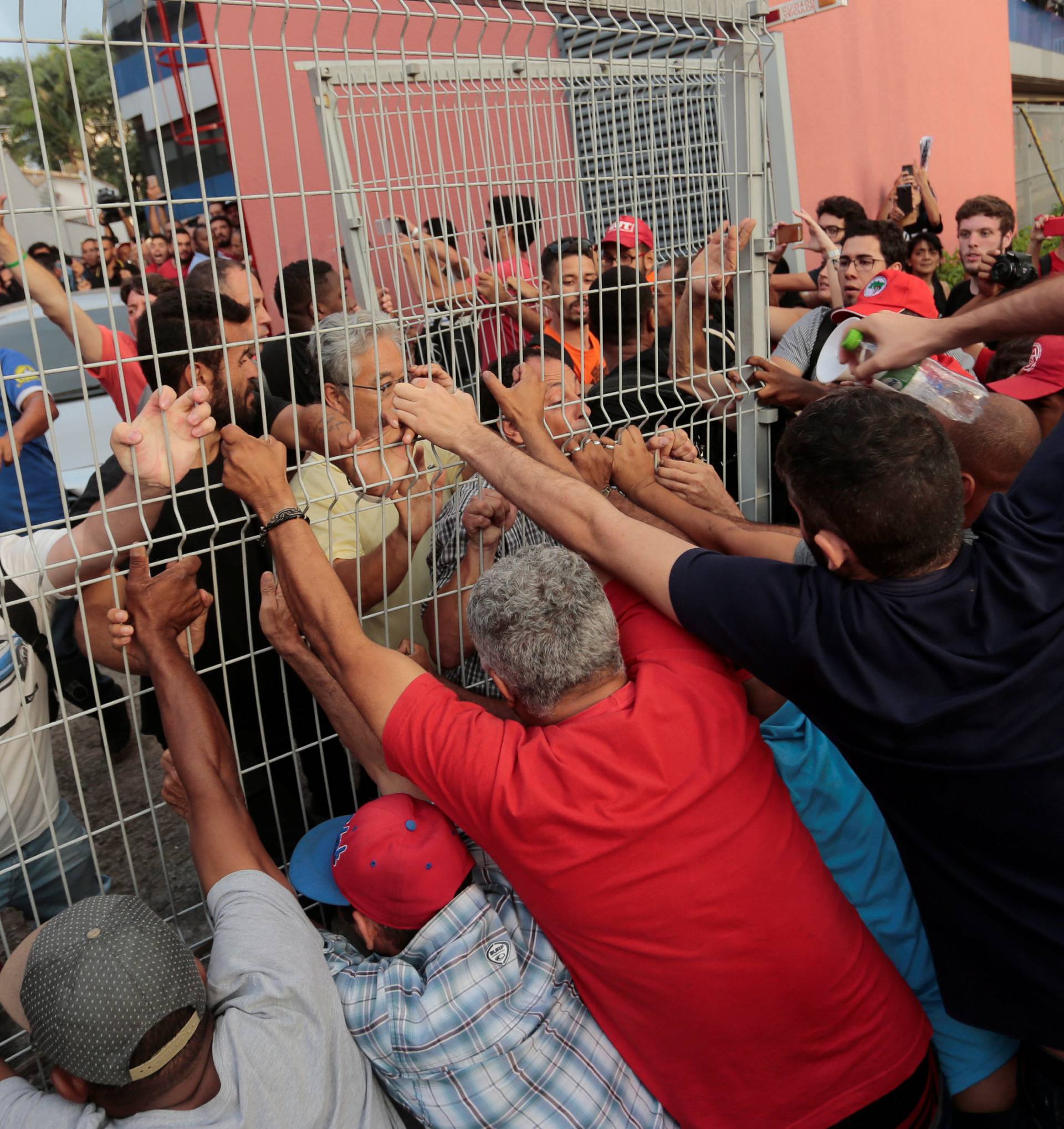 Supporters of former Brazilian President Luiz Inacio Lula da Silva block the way out as Lula tries to leave the metallurgic trade union in Sao Bernardo do Campo
