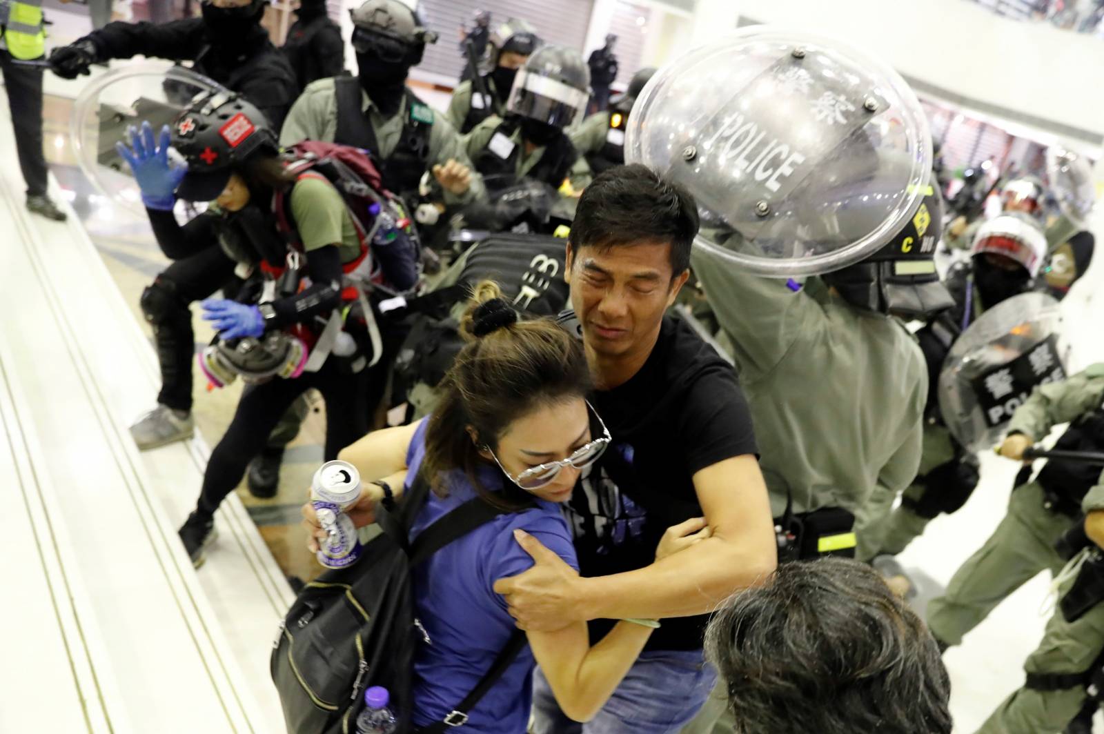 People scuffle with riot police at a shopping mall in Tai Po in Hong Kong