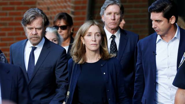 Actress Felicity Huffman and husband William H. Macy leave the federal courthouse in Boston