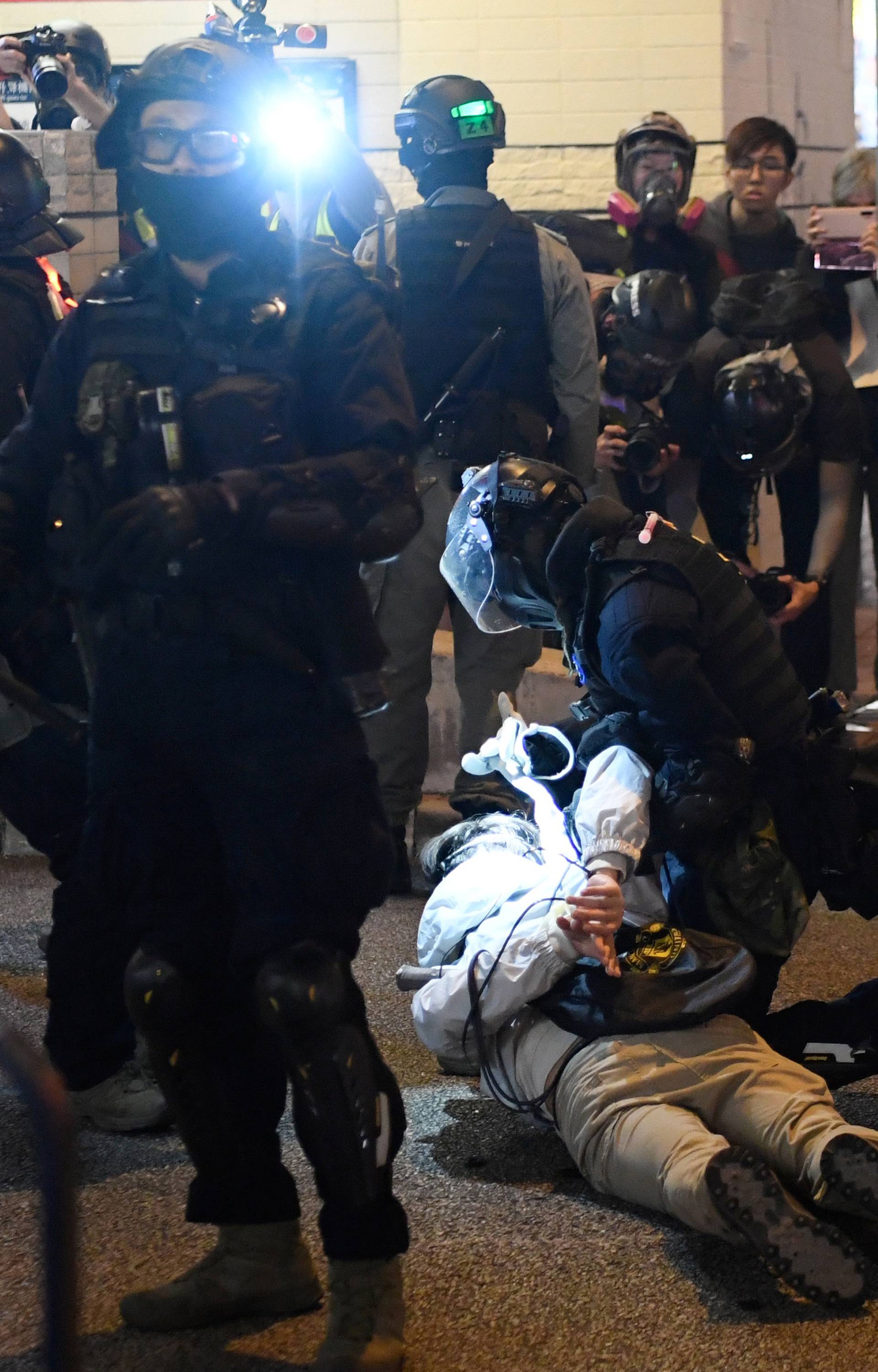 Riot police arrest a man in the neighbourhood of Hung Hom after a protest in Kowloon in Hong Kong