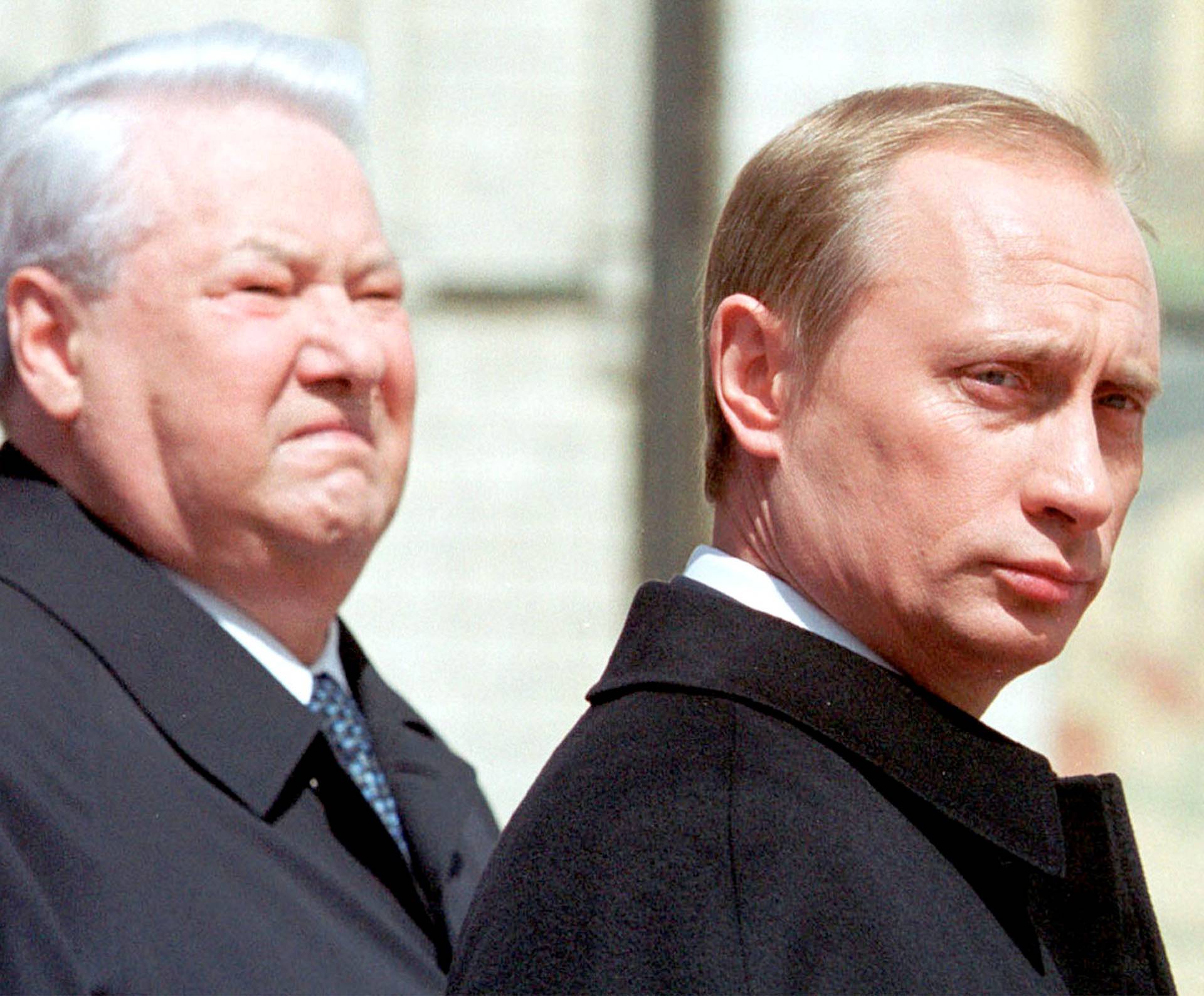 FILE PHOTO: The first Russian president Boris Yeltsin (L) stands with President Vladimir Putin