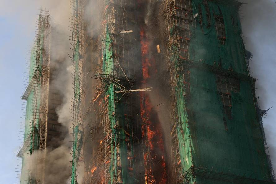 Flames engulf bamboo scaffolding across multiple buildings at Wang Fuk Court housing estate, in Tai Po
