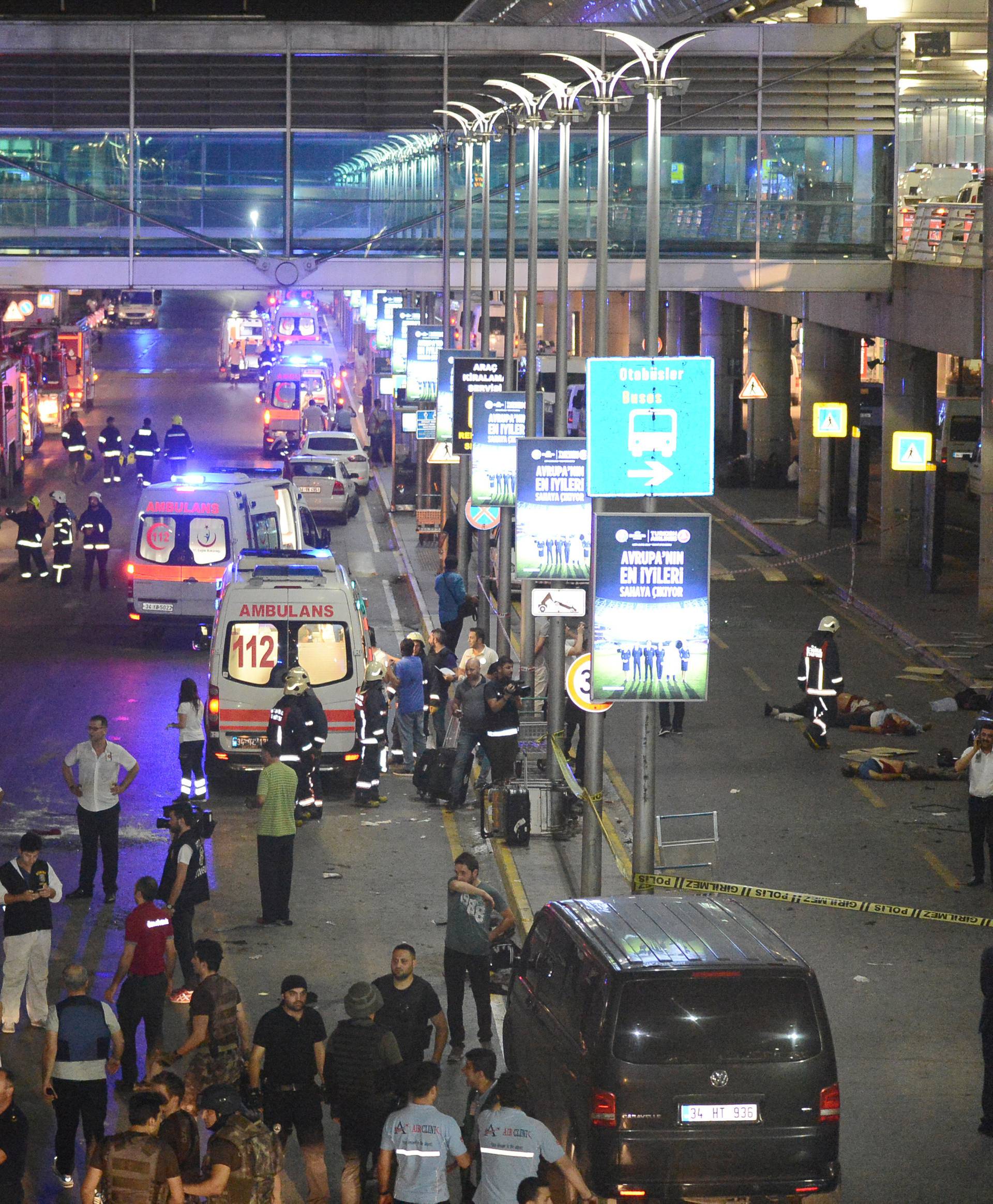 People walk outside Turkey's largest airport, Istanbul Ataturk following a blast