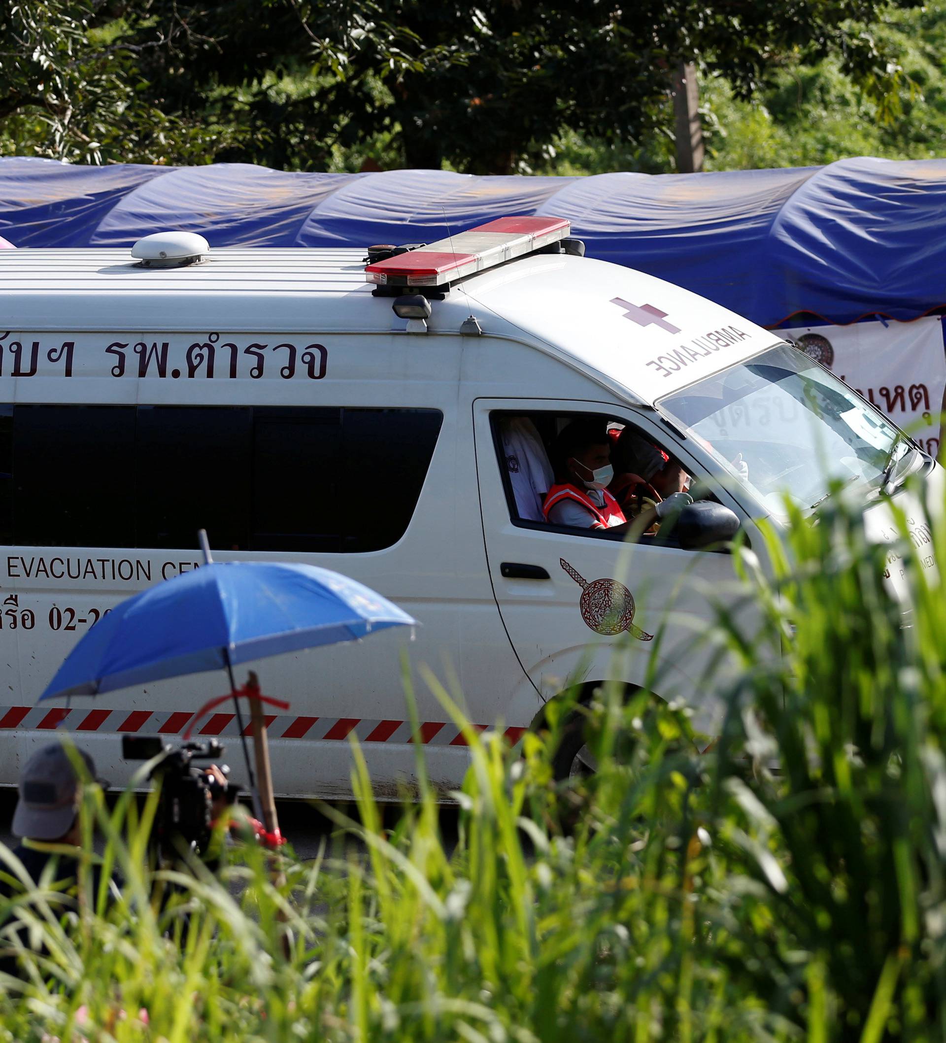 An ambulance believed to be carrying rescued schoolboys leaves from Tham Luang cave complex in the northern province of Chiang Rai