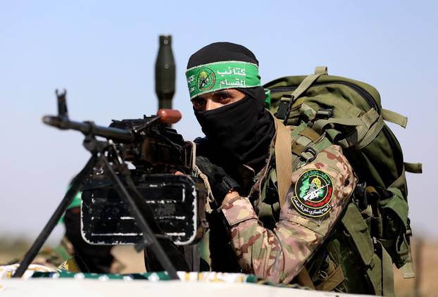 Gaza, Palestine. 20th July, 2023. A Palestinian fighter from the military wing of Hamas takes part during a military parade near the border with Israel in the central Gaza Strip, during a commemoration of the 2014 war, which lasted 51 days of the Israeli-