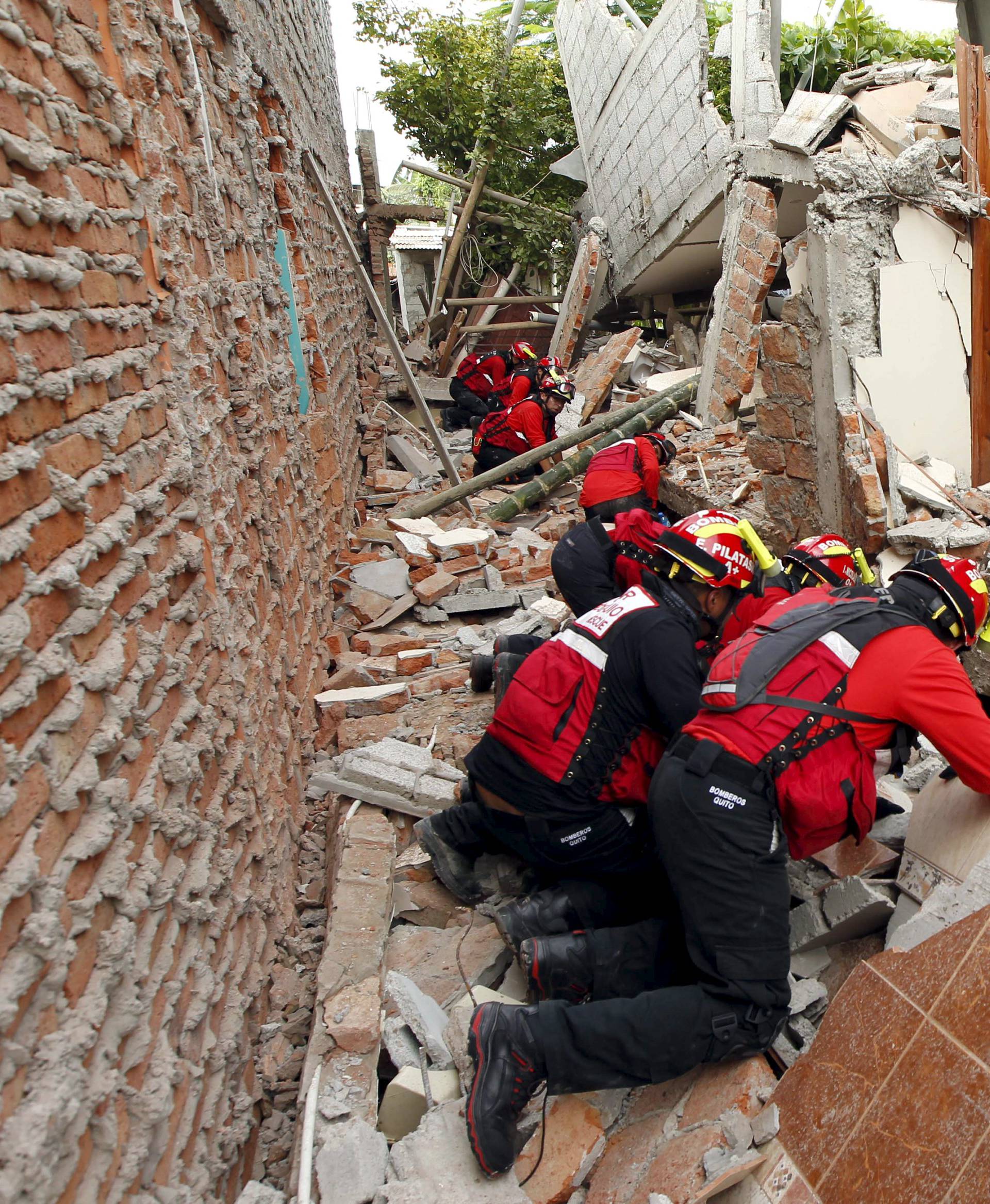 Firemen work after an earthquake struck off Ecuador's Pacific coast, at Tarqui neighborhood in Manta