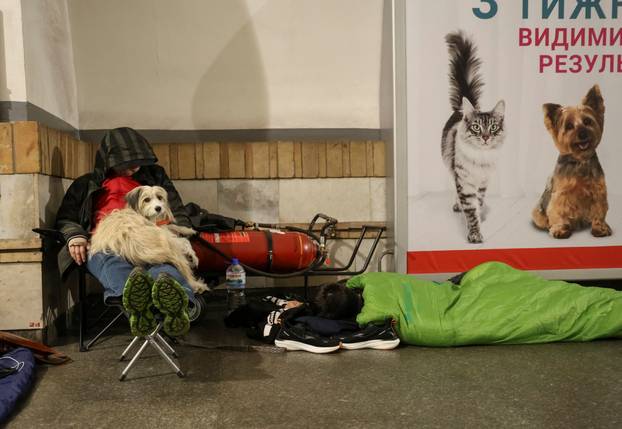 People take shelter inside a metro station during a Russian drone and missile strike in Kyiv